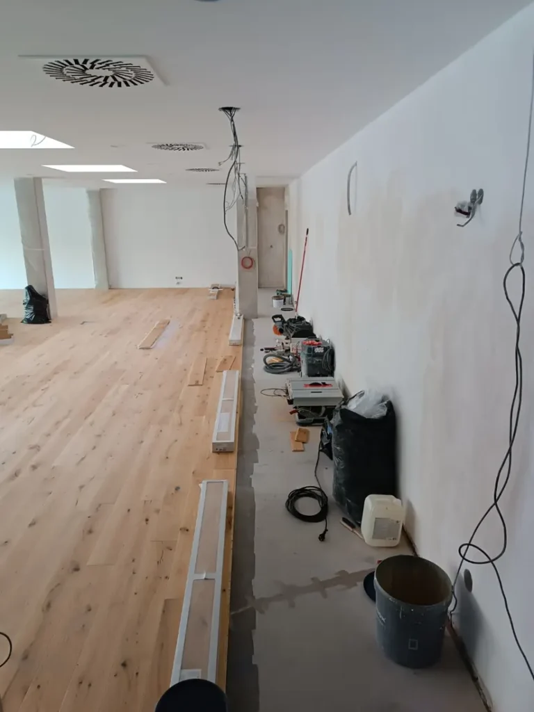 Pokládka masivní dřevěné podlahy ve velkém komerčním prostoru